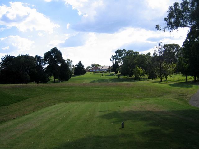 Armidale Golf Course - Armidale: Fairway view on Hole 7 with Club House in the distance.  Water trap over the first rise.