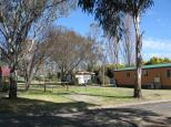 Armidale Tourist Park and YHA - Armidale: Powered sites for caravans and cottage in background