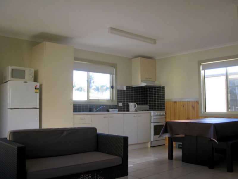 Surfrider Caravan Park - Barrack Point: Interior of cottage showing lounge room and kitchen dining area