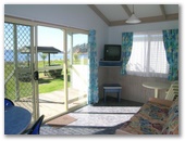 Clyde View Holiday Park - Batehaven: Lounge room and view from 2 Bedroom Beachfront Villa