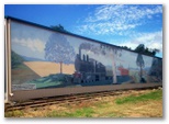 Bells N Whistles Accommodation Park - Bell: Mural adjacent to railway track