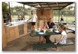 Brisbane Holiday Village - Eight Mile Plains: Sheltered BBQ area with tennis court in the background.
