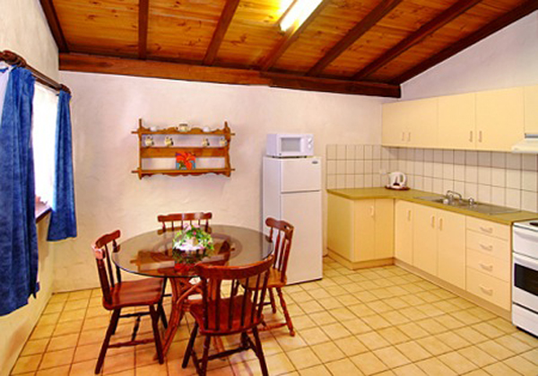 Sandy Bay Holiday Park - Busselton: Kitchen and dining area in Swiss Style Chalet