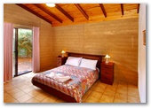 Sandy Bay Holiday Park - Busselton: Main bedroom in Rammed Earth Chalet
