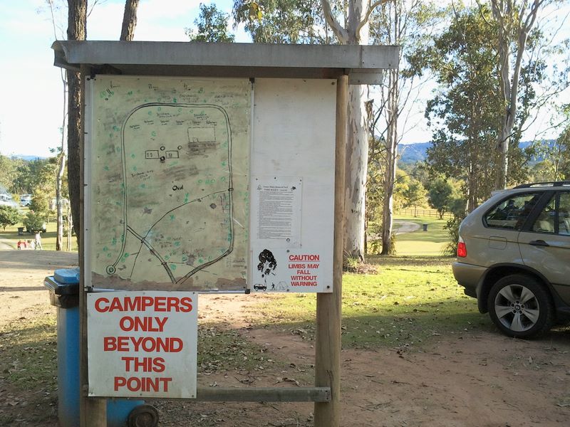 River Bend Country Bush Camping - Canungra: Overview of the park. Note the warning concerning falling limbs.