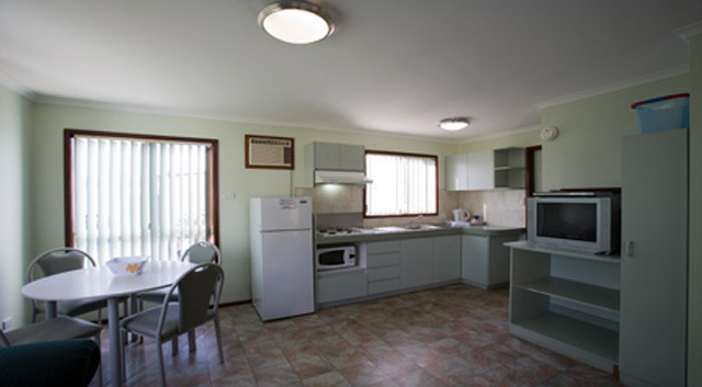 Coogee Beach Holiday Park - Coogee: Deluxe one bedroom studio showing kitchen and dining area.