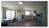 Coogee Beach Holiday Park - Coogee: Deluxe one bedroom studio showing kitchen and dining area.