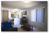 Coogee Beach Holiday Park - Coogee: Kitchen and lounge room in Deluxe Family Chalet