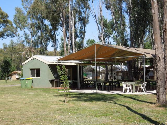 Corowa Caravan Park - Corowa: Corowa Caravan Park - camp kitchen. This area is well-appointed inside. There is even a BBQ outside for everyone to use. The outside area is partly covered, with plenty of tables and chairs available.