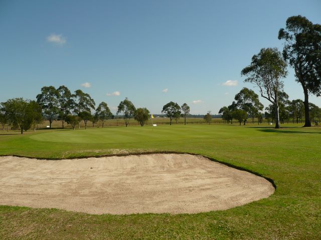 Orara Park Golf Course - Coutts Crossing: Green on Hole 9 guarded by large bunker.