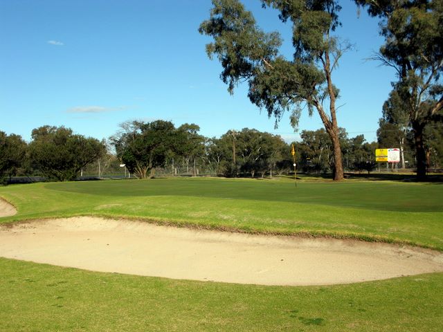 Cowra Golf Club - Cowra: Green on Hole 3 with large sand trap at the side.