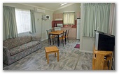 Joalah Holiday Park - Durras North: Lounge room in Waterview Standard Cabin