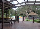 Emerald Beach Holiday Park - Emerald Beach: BBQ hut, camp kitchen, pool and jumping pillow area 