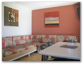 Wollongong Surf Leisure Resort - Fairy Meadow: Lounge room and dining area in one bedroom terrace apartment.