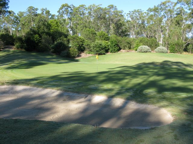 Grafton District Services Social Golf Club - Grafton: Green on Hole 2 with large bunker in front of the green.