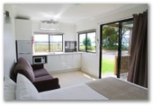 Anglers Rest Riverside Caravan Park - Greenwell Point: Lounge and kitchen in Studio 6