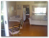 Riverlands Caravan Park and Wombat Cafe - Gunderman: Cabin lounge and dining area