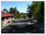 Twin Lakes Village Caravan Park - Gympie: Paved road leading down to office and scenic lake