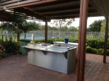 Gold Coast Holiday Park - Helensvale: Poolside tables and BBQs
