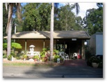 Woombah Woods Caravan Park - Woombah: Reception area with an arrival rest room nearby