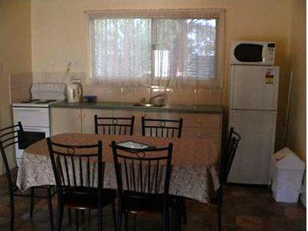Laura Community Caravan Park - Laura: Kitchen and dining area in family cabin.