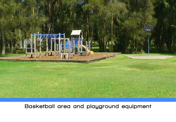 Weeroona Holiday Park - Manning Point: Basketball area and playground equipment.