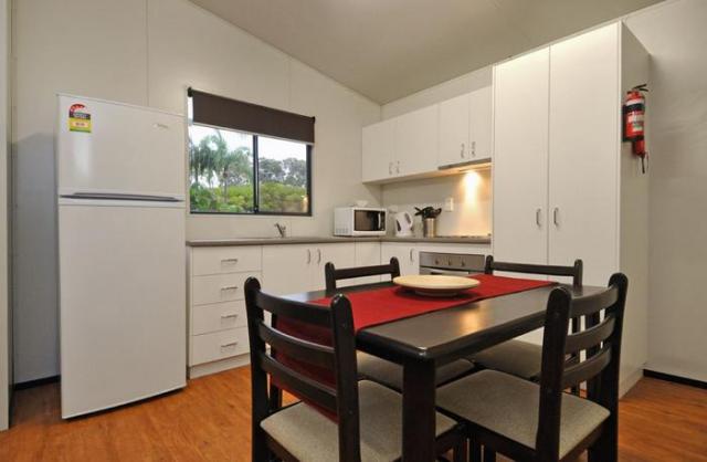 Nobby Beach Holiday Village - Miami: Kitchen and Dining Room in deluxe poolside villa