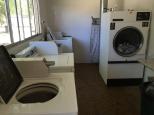 Acacia Gardens Caravan Park - Mooroopna: Interior view of the laundry.