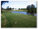 Nambucca Heads Island Golf Course - Nambucca Heads: Fairway view Hole 5 - a short pitch across the lake.  Don't be confused about the green. Follow the arrow on the tree to the left.