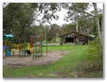 Lakes Bushland Caravan Park - Nicholson: Playground for children. With Camp Kitchen in the background.