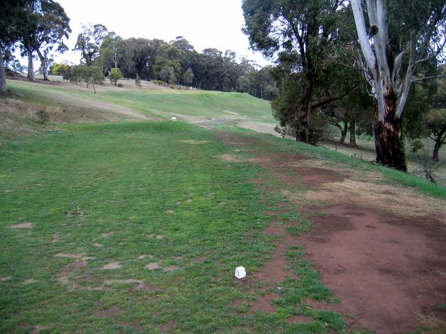 Oberon Golf Course - Oberon: Fairway view Hole 2 with steep banks around the green