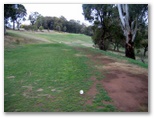 Oberon Golf Course - Oberon: Fairway view Hole 2 with steep banks around the green
