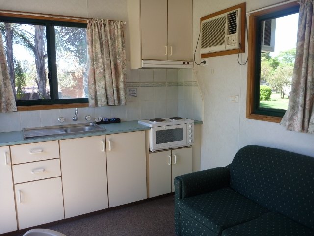 Currajong Caravan Park - Parkes: Interior of cabin showing kitchen and lounge