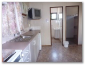 Currajong Caravan Park - Parkes: Interior of cabin showing kitchen