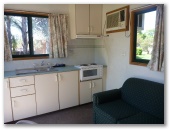 Currajong Caravan Park - Parkes: Interior of cabin showing kitchen and lounge
