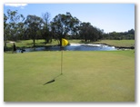 Redland Bay Golf Course - Redland Bay: Green on Hole 7 with water trap protecting the approach to the green