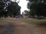 Riverton Caravan Park - Riverton: Playground, swimming pool other side of park fence.