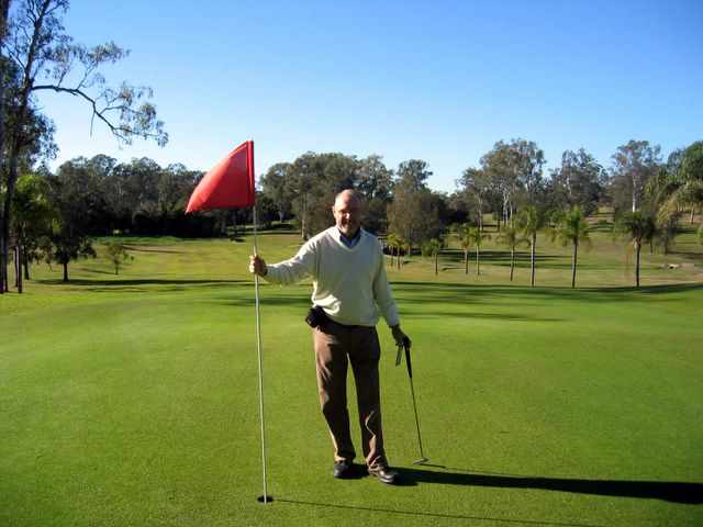 St Lucia Golf Links - St Lucia Brisbane: Holding the flag on Hole 9