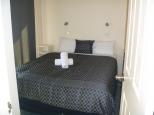 Boomerang Way Tourist Park - Tocumwal: Bed Room of Poolside Cabin 10