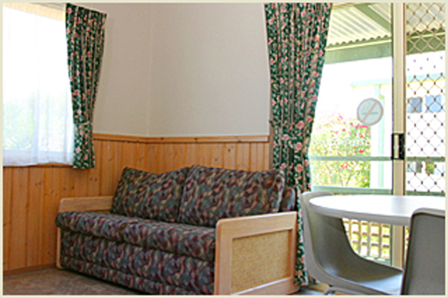 Barlings Beach Tourist Park - Tomakin: Lounge room in Spa Cabin