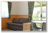 Barlings Beach Tourist Park - Tomakin: Lounge room in Spa Cabin