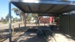 Yarrawonga West Rest Area - Yarrawonga: Sheltered picnic table and seats.