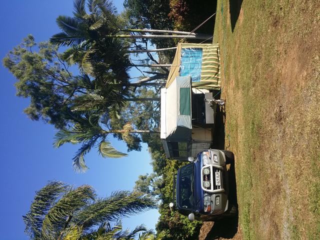 Poinciana Tourist Park - Yeppoon: Seperate grass area for larger vans meant we were able to hide away from the  main crowd in a shady secluded corner, but still with a clean shower block only a few steps away